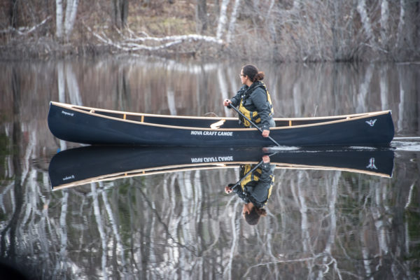 Tori Baird solo paddling a Blue Steel canoe