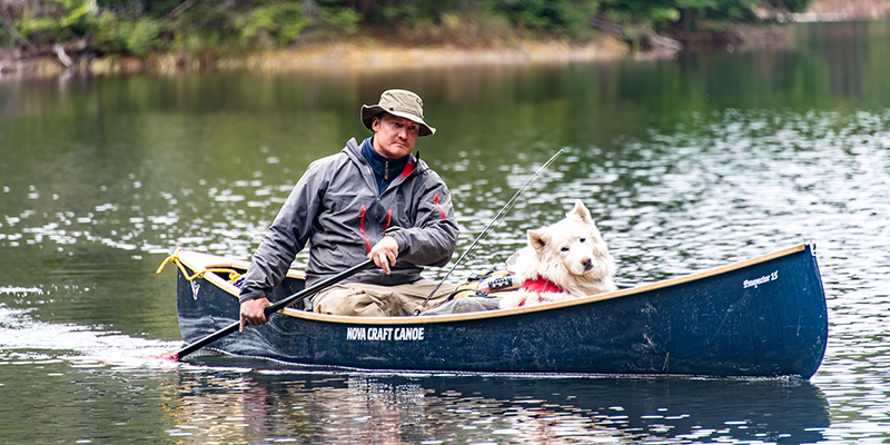 Man and dog in canoe