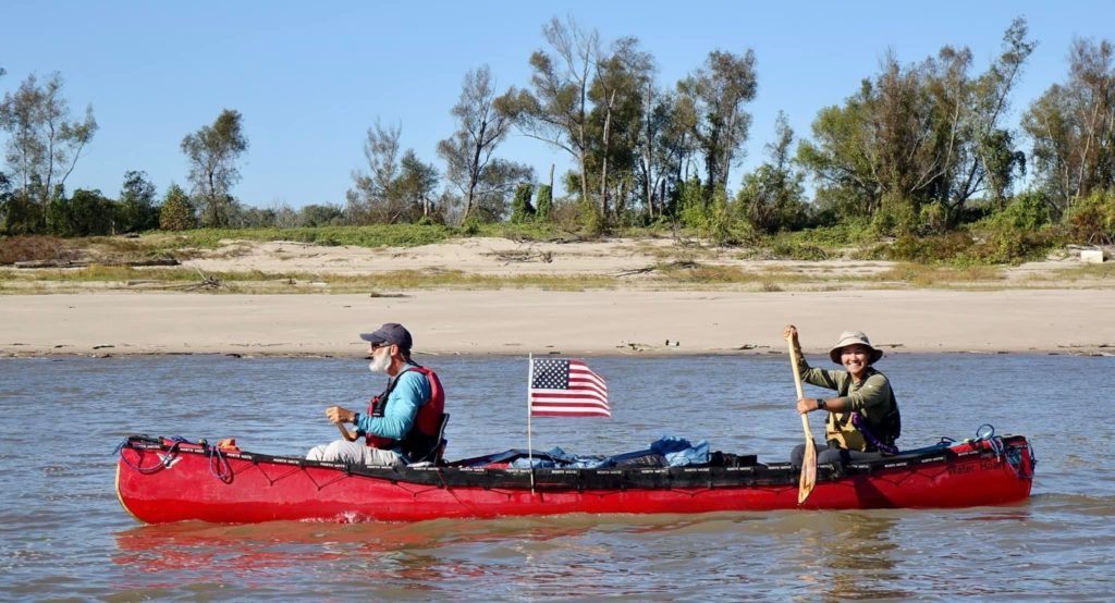 Father and daughter paddling the Mississippi by canoe
